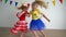 Hyperactive girls hold hands and spin fast. Naughty children. camera motion