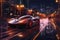 hypercars trail of light in nighttime cityscape