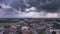 Hyperlapse aerial view of town under thunderstorm clouds