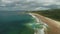 Hyperlapse aerial view: White beach gulf water crashing. People walking and playing with dogs