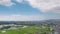 Hyperlapse: Clouds burn off over rice fields and distant bridge on sunny day