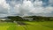 Hyperlapse: Clouds move over rice fields and small hillside neighborhood