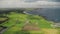 Hyperlapse farmlands fields aerial view in Antrim County, Ireland. Fast-track shot above countryside