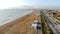 Hyperlapse fly over an empty beach and palm trees in the morning. Start of the tourist season in the middle sea