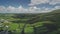 Hyperlapse Ireland rural scape aerial view: farmlands fields and cityscape with white houses, roads