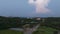 Hyperlapse: Lightning cloud forms over suburban road as day becomes night