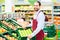 Hypermarket clerk filling up storage racks