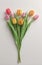 a hyperrealistic photograph of Lovely spring flowers and leaves, tulips white background of paper