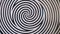 Hypnotic spiral circles in black and white.