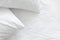 Hypoallergenic pillow in pillowcase over white linen sheets