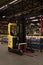 Hyster branded yellow forklift truck inside a factory industrial setting