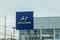 Hyundai car dealership sign with silver logo on a blue background