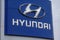 Hyundai car dealership sign with silver logo on a blue background