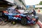 Hyundai team people tuning electric racing car in asphalt circuit pit