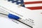 I-360 Petition for Amerasian, Widower or special immigrant blank form lies on United States flag with blue pen from Department of