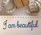 I am beautiful words written on copybook page with measure tape. Affirmation and fitness healthcare concept