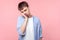 I am bored. Portrait of young lazy brown-haired man looking tired and disinterested at camera. indoor studio shot isolated on pink