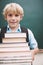 I can handle this. An eager young student carrying a tall stack of books and smiling at you.