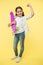 I can ride it. Kid girl happy holds penny board. Girl happy face carries penny board yellow background. Child learned