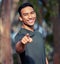 I challenge you to get your body moving. Portrait of a sporty young man pointing outdoors.