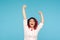 I am champion! Portrait of energetic enthusiastic woman with fancy red hair in shirt raising hands and shouting