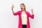 I am champion! Portrait of happy pleasure attractive blogger woman in pink blouse standing, holding phone, making selfie and