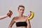 I choose fruits. Attractive tattooed woman with pierced nose refuses to eat meat offered to her, choosing bananas