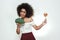 I choose healthy food! Pretty afro american woman is facing a choice of healthy broccoli or lollipop and looking at