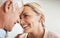 I could stare into these eyes all day. an affectionate mature couple standing face to face in their home.