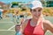 I did it. Cropped portrait of an attractive young woman holding up a trophy after winning a tennis match during the day.