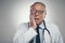 I didn't see this coming. Shot of an elderly male doctor in a studio against a grey background.