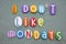 I do not like mondays, creative slogan composed with multi colored stone letters over green sand