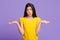 I Don`t Know. Careless Asian Girl Shrugging Shoulders Over Purple Studio Background