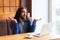 I dont no!Portrait of confused handsome young adult man freelancer in casual style sitting in cafe with laptop, raised hands and