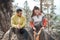 I have all we need in this backpack. two young athletes sitting together after a morning run through the woods.