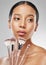 I have a big selection to work with. Studio shot of an attractive young woman holding a collection of makeup brushes