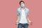 I have no money more. Portrait of sad bankrupt young man with surgical medical mask in blue shirt standing and showing his empty