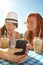 I have to share this. Two adolescent girls enjoying smoothies while texting on a cellphone.