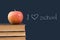 I \'heart\' school written on blackboard with apple,