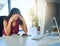 I just cant figure out the problem. a young businesswoman looking stressed out at her desk.