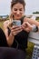 I just needed to check some of my texts quickly. a sporty young woman using a cellphone while exercising outdoors.