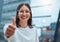 I knew you could do it. a young businesswoman showing thumbs up against an urban background.