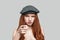 I know everything about you. Portrait of young rude redhead woman in headgear looking at camera and gesturing while