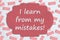 I learn from my mistakes sign on pink eraser