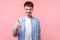 I like that, well done! Portrait of joyful brown-haired man gesturing thumbs up. indoor studio shot isolated on pink background