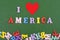 I love America word on green background composed from colorful abc alphabet block wooden letters, copy space for ad text