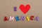 I love America word on paper background composed from colorful abc alphabet block wooden letters, copy space for ad text