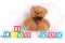 I love dad, photo with brown soft toy bear on the white background. The words are made with kids cubes, colorful letters.