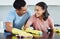 I love doing life with you. Shot of a young couple cleaning their kitchen together.