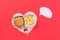 I love fast food. French fries in the form of heart isolated on red background